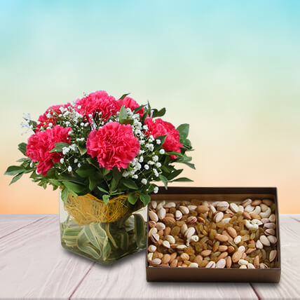 Pink Carnations In Glass Vase With Dry Fruits